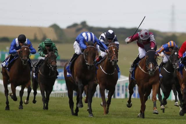 Paul Hanagan on Muhaarar, left, edges out the gallant Tropics, right, to win the July Cup at Newmarket. Picture: Getty