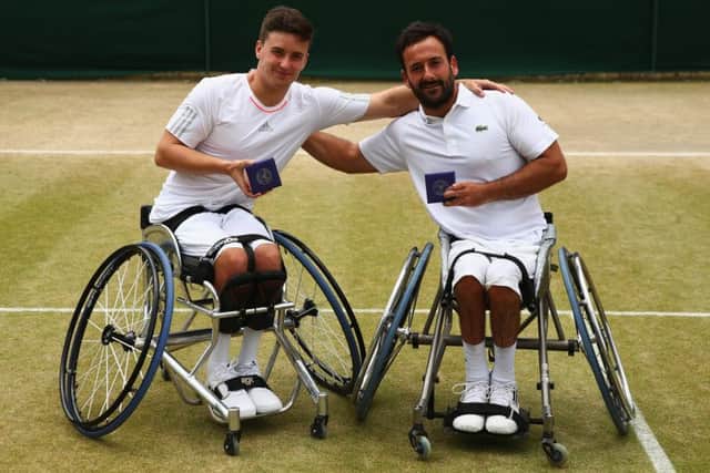 Gordon Reid, left, and playing partner Michael Jeremiasz pose with their runnersup medals after they lost out in the mens wheelchair doubles final. Picture: Getty Images