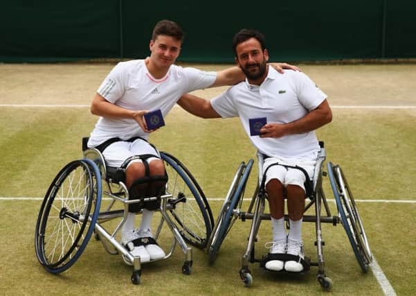 Gordon Reid, left, and playing partner Michael Jeremiasz pose with their runnersup medals after they lost out in the mens wheelchair doubles final. Picture: Getty Images