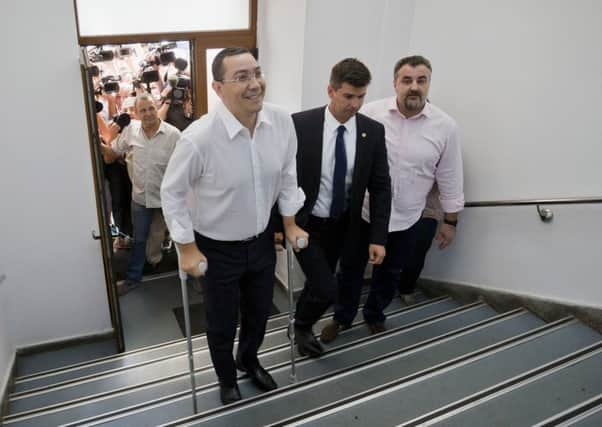Romanian premier Victor Ponta walks up the stairs of the national anti-corruption prosecutors office in Bucharest to be questioned. Picture: AP