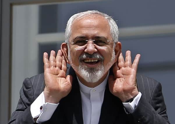 Iranian Foreign Minister Mohammad Javad Zarif gestures as he talks to journalist from a balcony of the Palais Coburg hotel. Picture: Getty/AFP