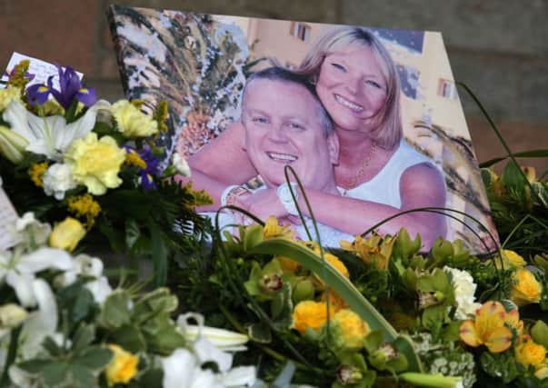A photograph of Billy and Lisa Graham sits beside flowers at their funeral at Perth Crematorium. Picture: PA