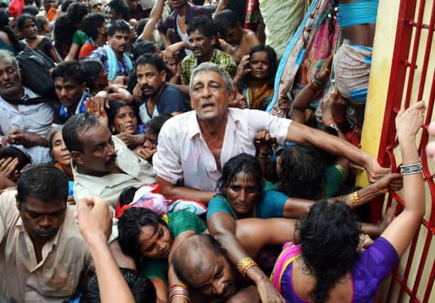 Indian devotees gather after the stampede at a religious festival in Godavari. Picture: AFP/Getty