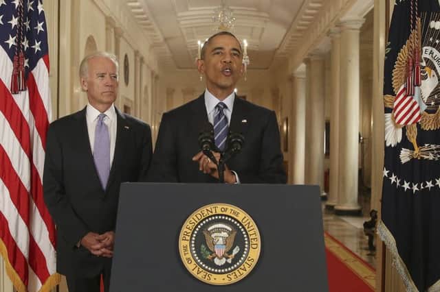 An upbeat Barack Obama, flanked by vicepresident Joe Biden, hails the landmark deal. Picture: AP
