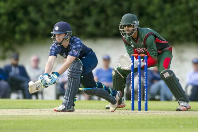 Scotland's Matthew Cross, left, sweeps the ball away. Picture: Donald MacLeod
