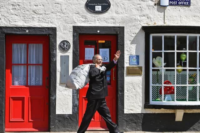 Sanquhar post office postmaster Dr Manzoor Alam gets the hang of his new role. Picture: Getty Images