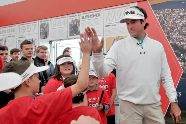 American Bubba Watson high-fives a young fan in the St Andrews spectator village during a Golf Roots workshop. Picture: Jane Barlow