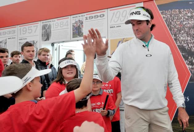 American Bubba Watson high-fives a young fan in the St Andrews spectator village during a Golf Roots workshop. Picture: Jane Barlow