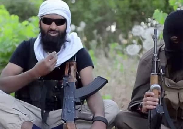 A screen grab of Abdul Raqib Amin, left, who has released a bizarre recruitment video on behalf of terrorist organisation Isis. Picture: Hemedia