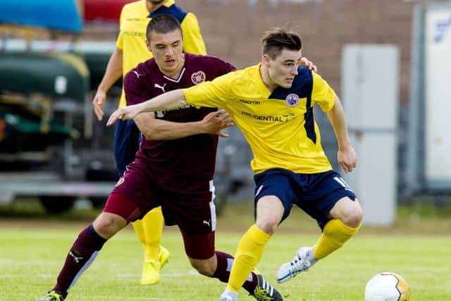 Hearts' Leon Jones (left) tries to win possession from Sean Dickson. Picture: SNS