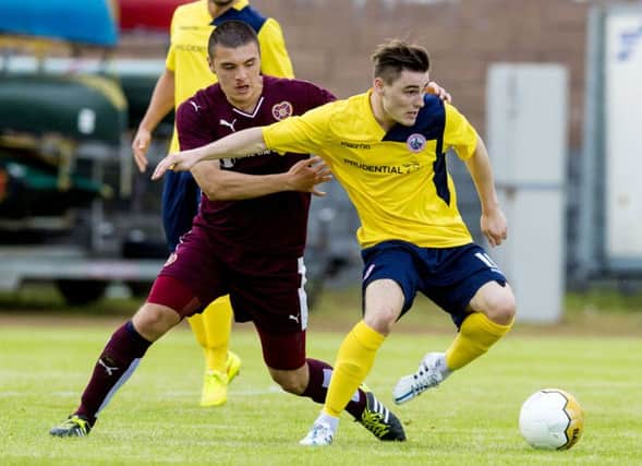 Hearts' Leon Jones (left) tries to win possession from Sean Dickson. Picture: SNS