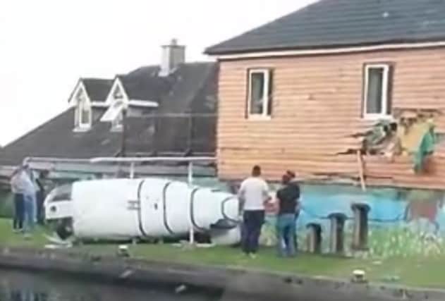 The helicopter can be seen lying on its side, with damage to the pub. Picture: YouTube / Screengrab