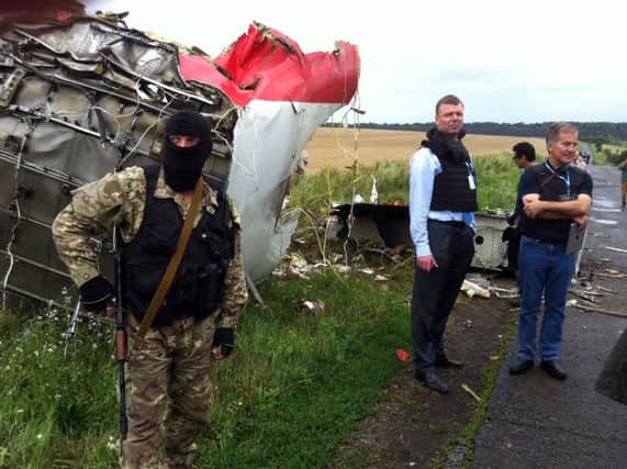 Investigators visit the crash site in eastern Ukraine in July last year. Picture: Getty