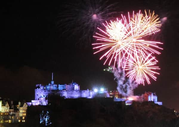 Fireworks above Edinburgh Castle and Princes Street at midnight during the New Year celebrations. Picture: Jane Barlow