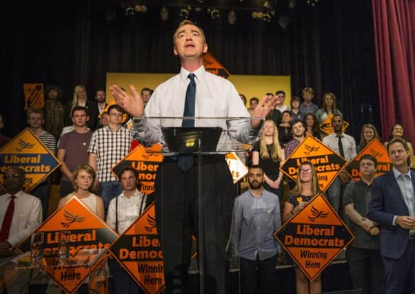 Tim Farron is appointed new leader of the Liberal Democrats, watched by his predecessor Nick Clegg. Picture: Getty