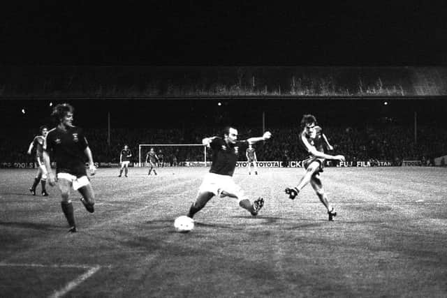 Ipswich captain Mick Mills lunge is in vain as winger Peter Weir scores one of his two goals. Picture:SNS