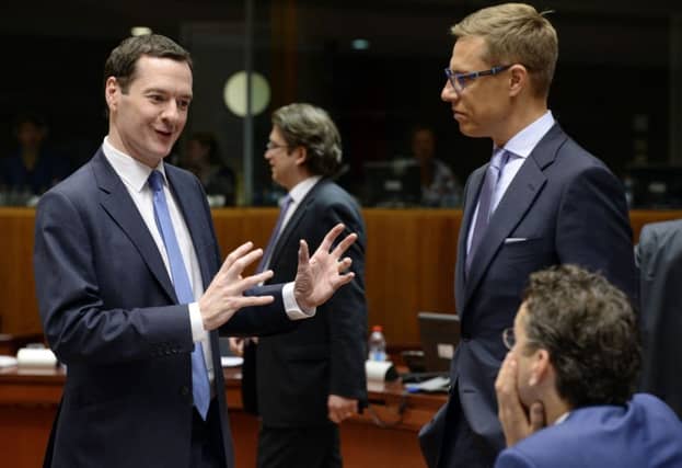 George Osborne talks to Jeroen Dijsselbloem, right, and Alexander Stubb in Brussels last week. Picture: Getty