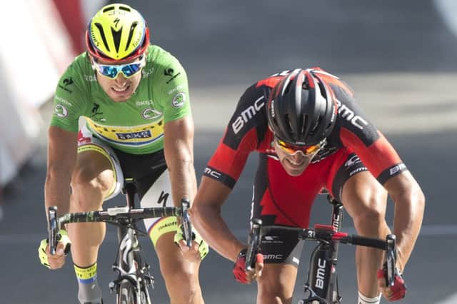 Peter Sagan, wearing the green points leaders jersey, grimaces as he sees Greg van Avermaet cross the line first. Picture: AP