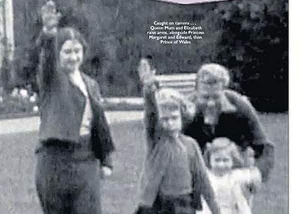 A still of footage from 1933 on The Sun's front page that shows a young Queen performing a Nazi salute with her family at Balmoral. Picture: PA