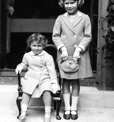 The Queen pictured circa 1933 aged 7 with her two-year old sister Princess Margaret (seated). Picture: PA