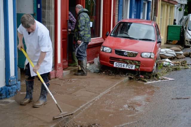 People begin the cleanup following heavy rain which has caused flooding in Alyth. Picture: Getty