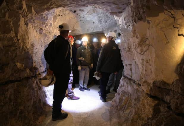 National Trust staff explore the Fan Bay Deep Shelter carved into the chalk underneath the white cliffs of Dover. Picture: PA