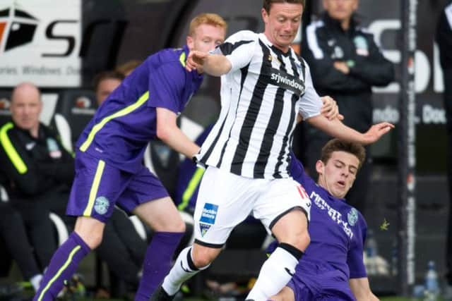 Aaron Dunsmore slides into a challenge on Dunfermlines Joe Cardle during Hibs friendly victory. Picture: SNS