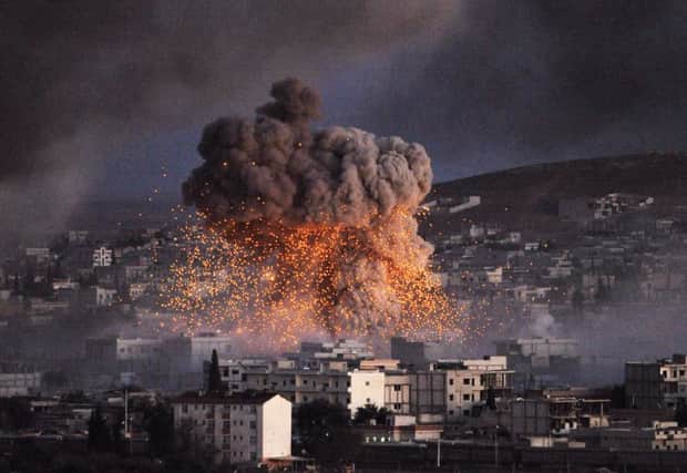 An explosion rocks the Syrian city of Kobani during a reported suicide car bomb attack by IS. Picture: Getty