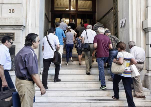 Greeks still face strict controls over how much they can withdraw as banks hit by the bailout crisis reopened yesterday. Picture: Getty