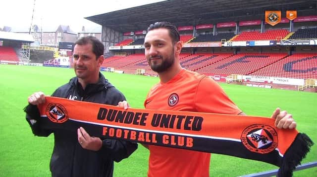 Bodul holds up the scarf at Tannadice after completing his move from Austria. Picture: Facebook