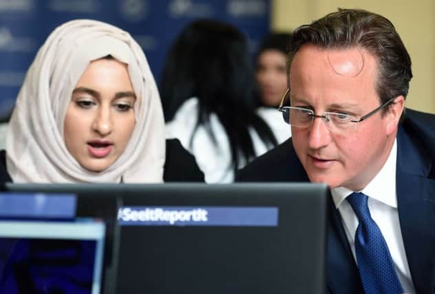 David Cameron speaks with Zahra Qadir during a workshop in Birmingham about online radicalisation. Picture: AFP/Getty Images