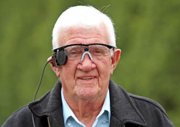 Partially sighted pensioner Raymond Flynn shows off his sight-restorinig gadget. Picture: PA
