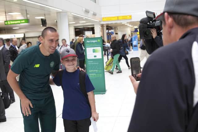 Celtic captain Scott Brown greets fans at Glasgow Airport before the squad flew out to Iceland. Picture: SNS