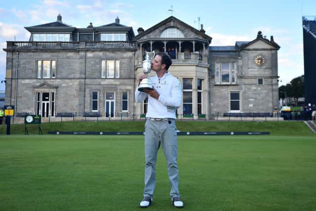 Zach Johnson kisses the Claret Jug in front of the Royal and Ancient clubhouse. Picture: Getty