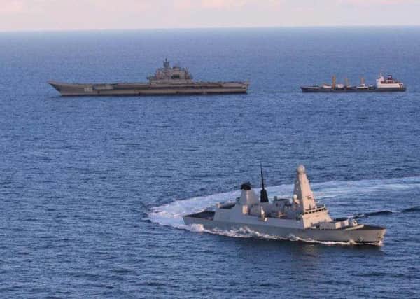 HMS Defender, in the foreground, escorts Russian aircraft carrier Admiral Kuznetsov off the coast of Moray. Picture: Contributed