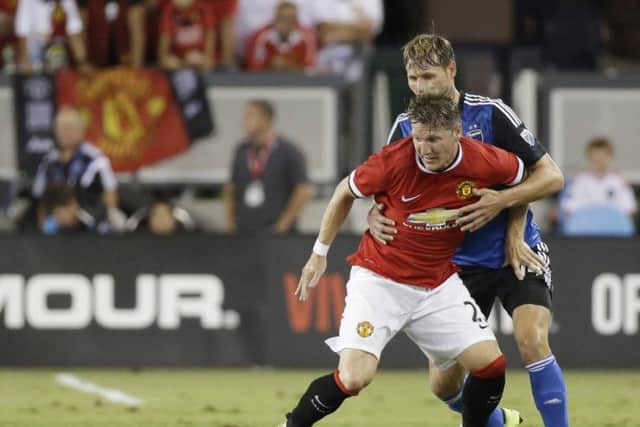Bastian Schweinsteiger vies with Adam Jahn during Manchester Uniteds 31 win at the Champions Cup. Picture: AP