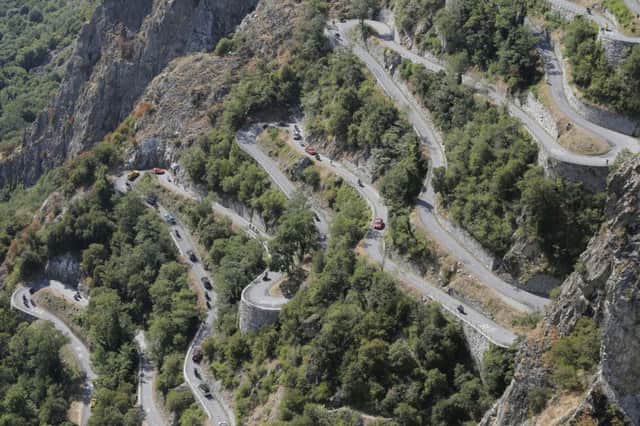 Riders, team cars and press motorcycles climb the hairpins of Montvernier during the 18th stage of the Tour de France. Picture: AP