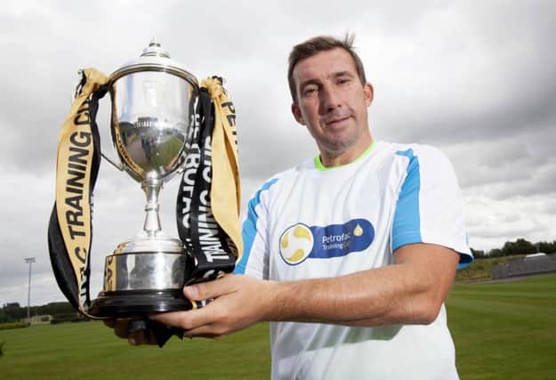 Alan Stubbs, with the Petrofac Cup yesterday, is looking forward to opening the campaign. Picture: SNS