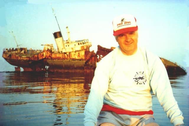 Diving expert Bob Baird in front of HMS Switha before it sank. Picture: Mike Merritt