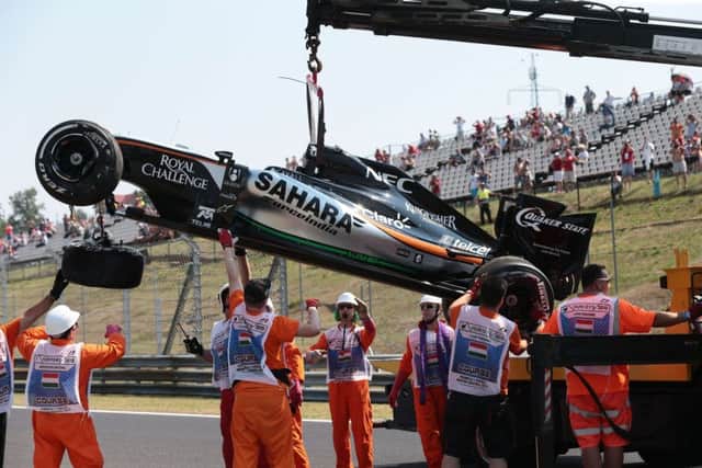 Marshalls remove Sergio Perezs car after the Mexican crashed during yesterdayss practice session in Hungary. Picture: AFP/Getty
