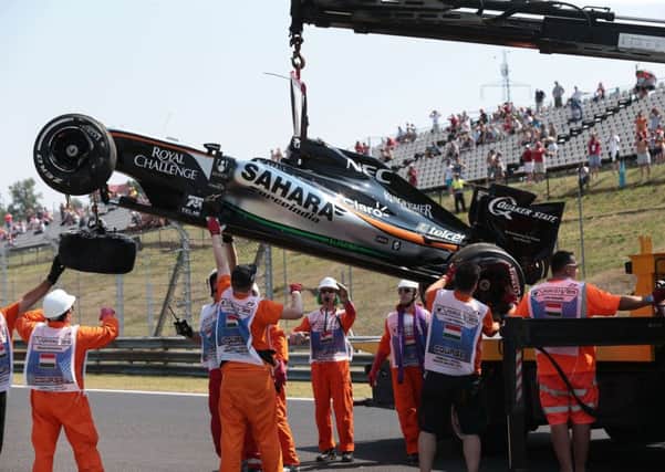 Marshalls remove Sergio Perezs car after the Mexican crashed during yesterdayss practice session in Hungary. Picture: AFP/Getty