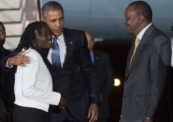 Barack Obama greets half-sister Auma and president Uhuru Kenyatta in Nairobi. Picture: AFP/Getty Images