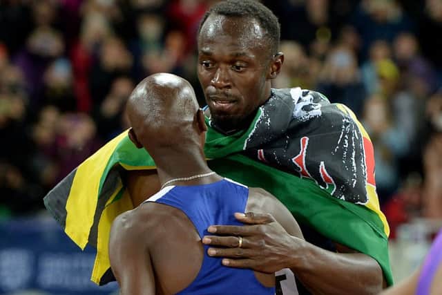 Mo Farah takes a break from his build-up to the 3,000m to congratulate Usain Bolt on his 100m final success. Picture: PA