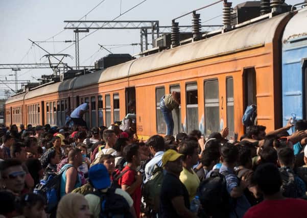Migrants board a train on the Macedonian-Greek border heading for Serbia. Picture: AFP/Getty Images