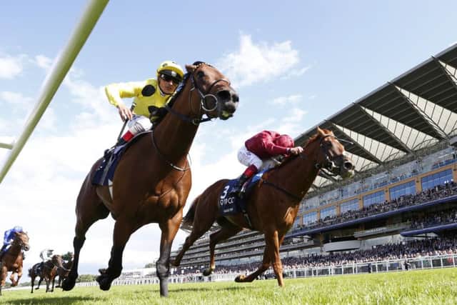 Postponed, left, stages a late rally to win the King George VI Stakes at Ascot by a nose from Eagle Top. Picture: Getty Images