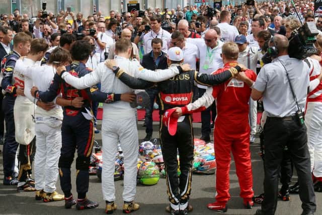 Formula 1 drivers embrace for a minutes silence to remember Jules Bianchi before the Hungarian Grand Prix.  Picture: AP