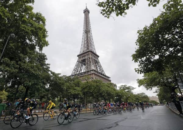 The pack with Britains Chris Froome, wearing the overall leaders yellow jersey, passes the iconic Eiffel tower. Picture: AP