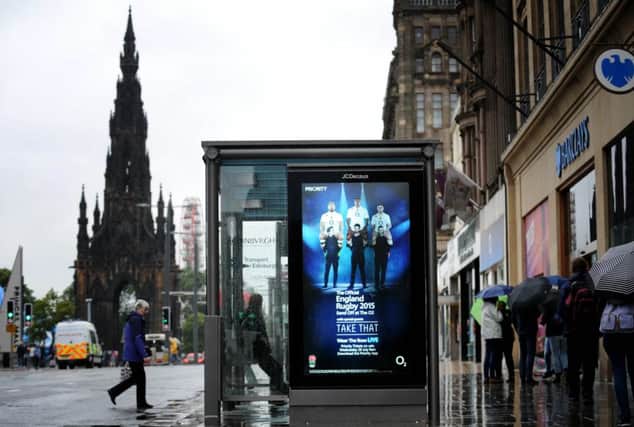 One of the misplaced adverts featuring the England rugby team and pop group Take That, on a Princes Street bus shelter. Picture: Jane Barlow