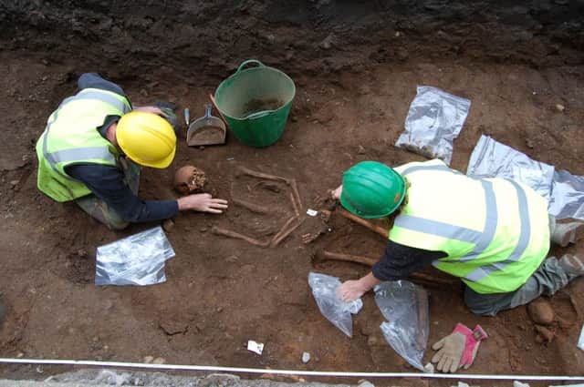 The remains are painstakingly unearthed in the quadrangle. They date from the 13th century. Picture: HEMEDIA
