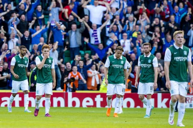 Hibernian players stand dejected at full-time. Picture: SNS